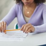 woman holding a pencil